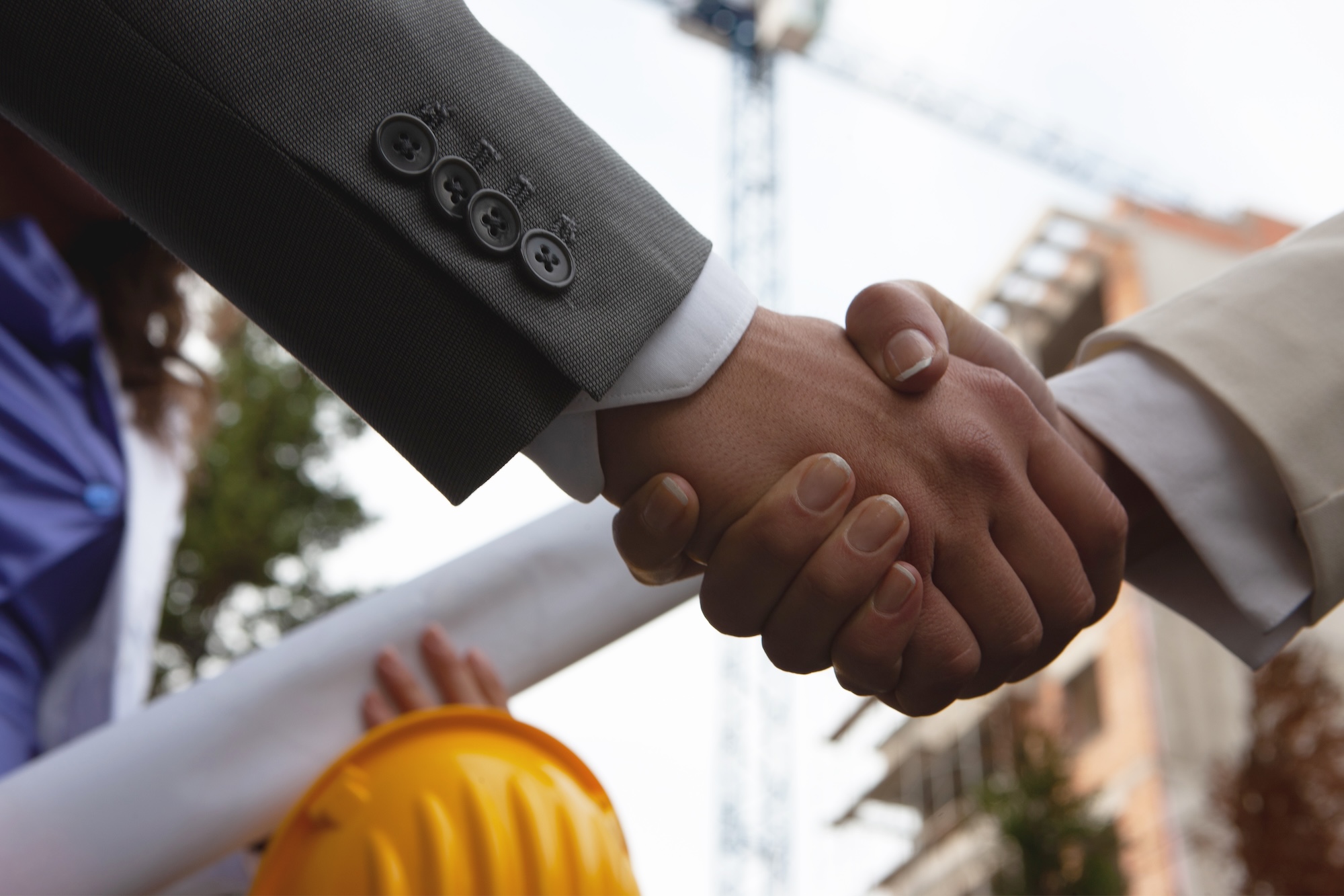 Shaking hands on construction